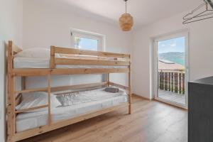 a bedroom with two bunk beds and a balcony at Mountain View Suites in Tisens +45 photos