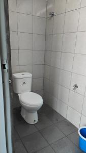 a bathroom with a white toilet in a stall at Tido Cottage in Macang