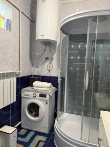 a bathroom with a washing machine and a washer at Son kol Keng suu guesthouse in Keng-Suu +9 photos