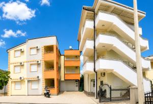 an apartment building with white and orange balconies at Apartments Leyla in Ulcinj