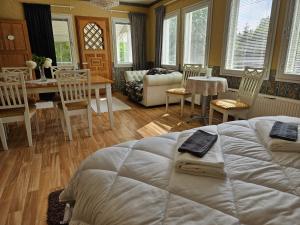 a bedroom with a bed and a table and chairs at Villa Gargano in Pieksämäki +10 photos