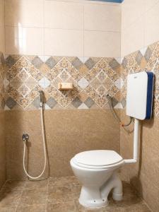 a bathroom with a toilet and a shower at Avora Auroville in Auroville