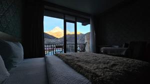 a bedroom with a bed and a view of a mountain at Best view Kazbegi in Kazbegi +18 photos