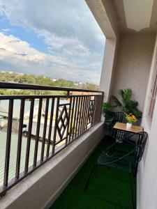 a balcony with a chair and a view of the water at UrbanHive Naivasha Townhouse in Naivasha