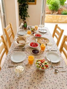 a table with plates and bowls of food on it at Astir Studios in Stalís