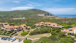 an aerial view of a house on a hill next to the ocean at Appartamento La Pelosa in Stintino