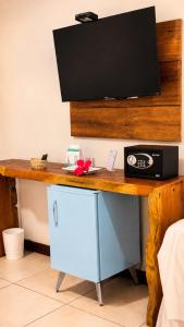 a desk with a television on top of it at Pousada Alto da Vila Noronha by Alto da Ilha in Fernando de Noronha
