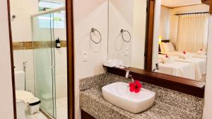 a bathroom with a sink and a mirror at Pousada Alto da Vila Noronha by Alto da Ilha in Fernando de Noronha +79 photos