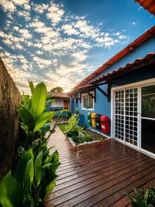 a wooden deck in front of a house at Pousada Alto da Vila Noronha by Alto da Ilha in Fernando de Noronha