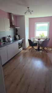 a kitchen with a table and chairs in a room at Villa Basilika - Ferienwohnung Prüm in Prüm +61 photos