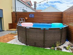 a hot tub with two frisbees on top of it at Cabo da Vila Guesthouse in Ribeira Grande