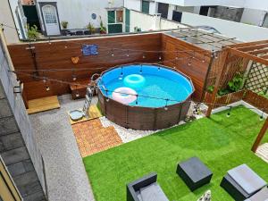 an overhead view of a swimming pool in a backyard at Cabo da Vila Guesthouse in Ribeira Grande