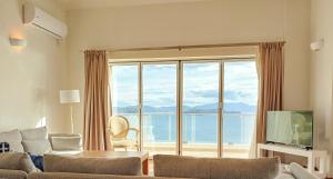 a living room with a view of the ocean at Gaia Skiathos Apartments in Achladies