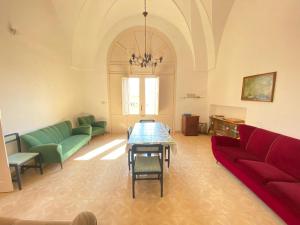 a living room with a table and a couch at Salento mare in Casalabate