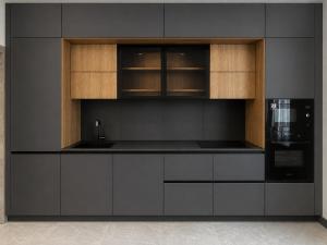 a kitchen with black and wooden cabinets and a microwave at Graphite House in Kyiv