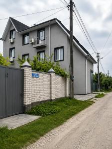a house on the side of a road with a fence at Graphite House in Kyiv