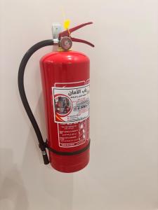 a fire hydrant with a hose attached to it at شقق حديثة موثثة in Dammam