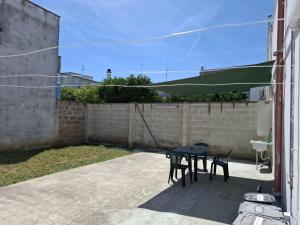 a patio with a table and chairs and a fence at B&B Martina in Martignano