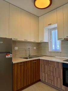 an empty kitchen with a sink and a refrigerator at Villa 3 in Velipojë