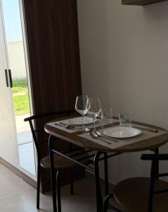 a wooden table with wine glasses on it at Villa 3 in Velipojë +10 photos