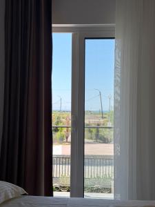 a bedroom door with a view of a field at Villa 3 in Velipojë