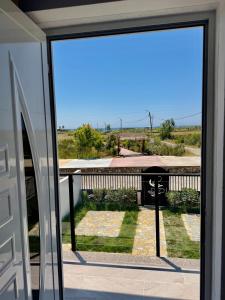 a sliding glass door with a view of a yard at Villa 3 in Velipojë