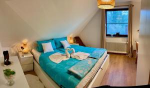 a bedroom with a blue bed with a bow on it at Chez Lana in Berlin