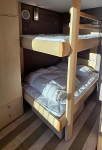 two bunk beds in a room with at Appartement l'Ariondaz in Courchevel