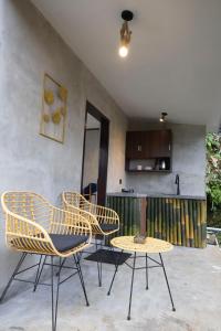 a group of chairs and a table on a patio at The Beauty Riptide in Karangasem