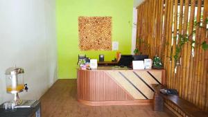 a lobby with a reception desk in a room at Melati Hotel central kuta mandalika in Kuta Lombok