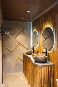 a bathroom with two sinks and two mirrors at The Beauty Riptide in Karangasem +45 photos