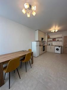 a kitchen with a table and chairs in a room at квартира in Odesa