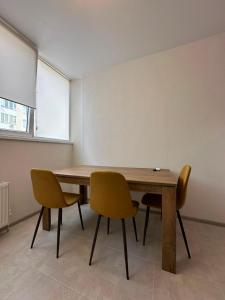 a room with a wooden table and two chairs at квартира in Odesa +2 photos