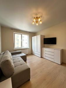 a living room with a couch and a flat screen tv at квартира in Odesa