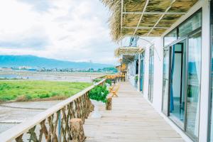 a balcony of a hotel with benches and tables at Mường Thanh Garden Stay in Dien Bien Phu