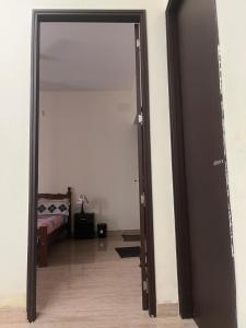 an open door to a bedroom with a bed at Sai VVR homestay in Chennai