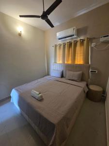 a bedroom with a large bed with a fan at Sai VVR homestay in Chennai