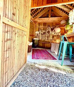 a room with a wooden house with a table and a rug at Maison VCB Ciney - Hôtel Particulier de 1820, Cœur de Ville, Parc & Parking Privé in Ciney