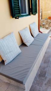 two pillows sitting on a mattress against a wall at ainos cottage in Kambitsáta