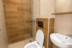 a bathroom with a toilet and a sink at Jason Apartments in Paralia Katerinis +28 photos
