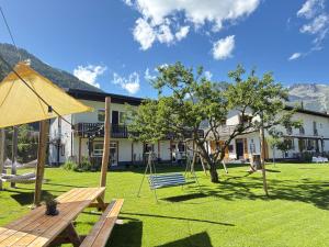 a park with a swing and a building at Mallnbach Apartments in Mallnitz