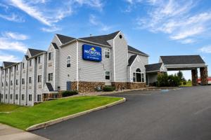 a hotel with a sign on the side of a building at Microtel Inn & Suites by Wyndham Bozeman in Bozeman