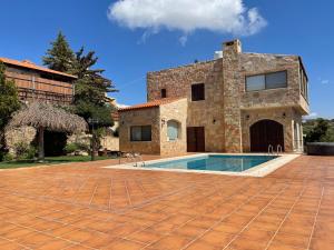 a stone house with a swimming pool in front of it at Horizon 4 - Amman in Amman