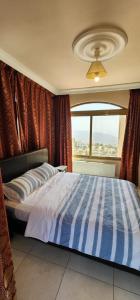 a bedroom with a large bed with a window at Horizon 4 - Amman in Amman +74 photos