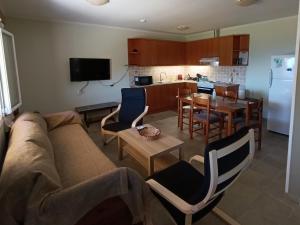 a living room with a couch and a kitchen at ainos cottage in Kambitsáta