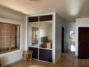 a living room with a large glass partition with a table at Horizon 4 - Amman in Amman