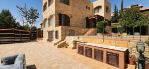 a large house with a courtyard in front of it at Horizon 4 - Amman in Amman