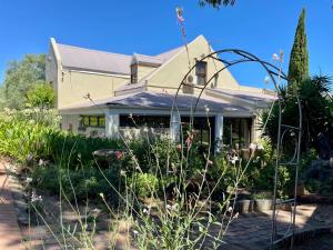 a house with a garden in front of it at UnderHill Farm in Klipkraal +157 photos