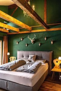 a bedroom with a bed with antlers on the wall at Säntisblick in Oberstaufen