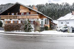a wooden house on the side of a street at Säntisblick in Oberstaufen